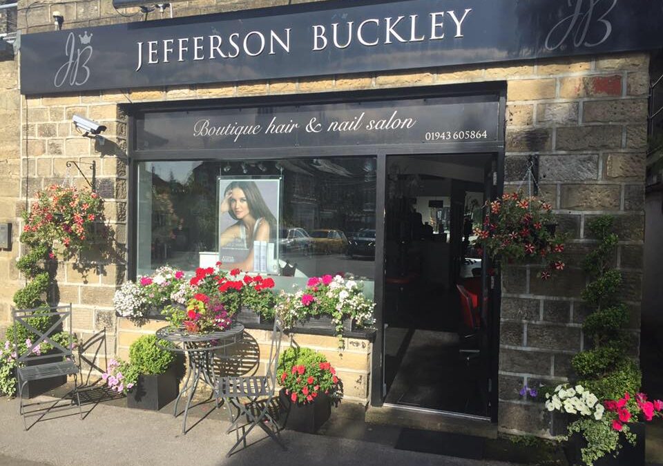 Jefferson Buckley shopfront on Brook Street with its serif sign and hanging flowers