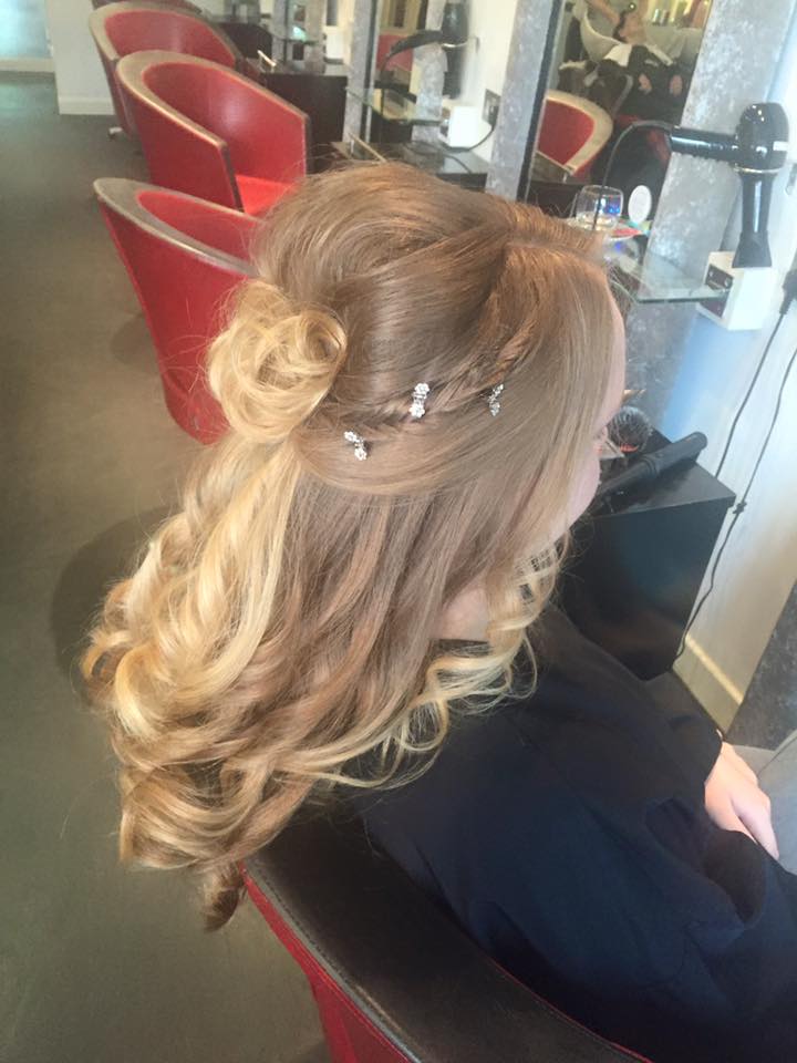 Soft blonde curls with a half-up twist and delicate hair accessories